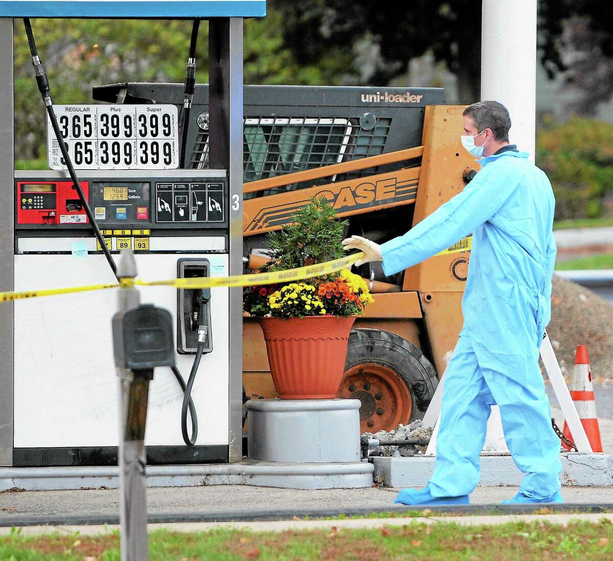 (Peter Hvizdak — Register) Connecticut State Police investigate the fatal shooting of a robbery suspect by a trooper Wednesday at Patriot Fuels gas station, 719 Boston Post Road, by West River Street, Milford. Matthew S. Lofaro, 28, died after being shot by Trooper 1st Class James Scott. The incident is under investigation.
