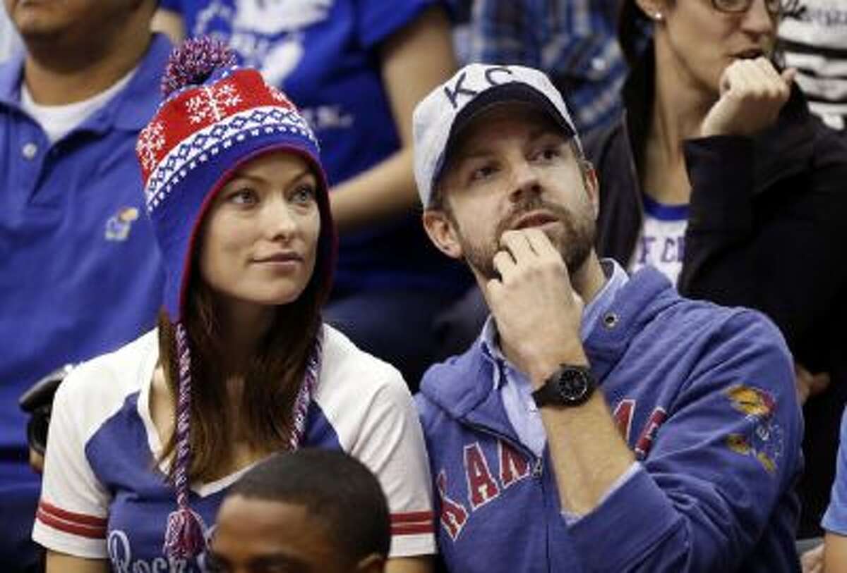 In this Dec. 29, 2012 file photo provided by Kansas University, actress Olivia Wilde, left, and actor Jason Sudeikis watch Kansas play American in an NCAA college basketball game in Lawrence, Kan.