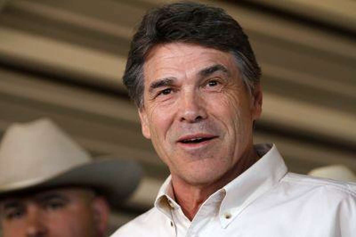 Texas Governor Rick Perry answers questions from the media after taking an aerial tour over the fertilizer plant explosion site in West, Texas, April 19, 2013. (Jaime R. Cerrero/Reuters)