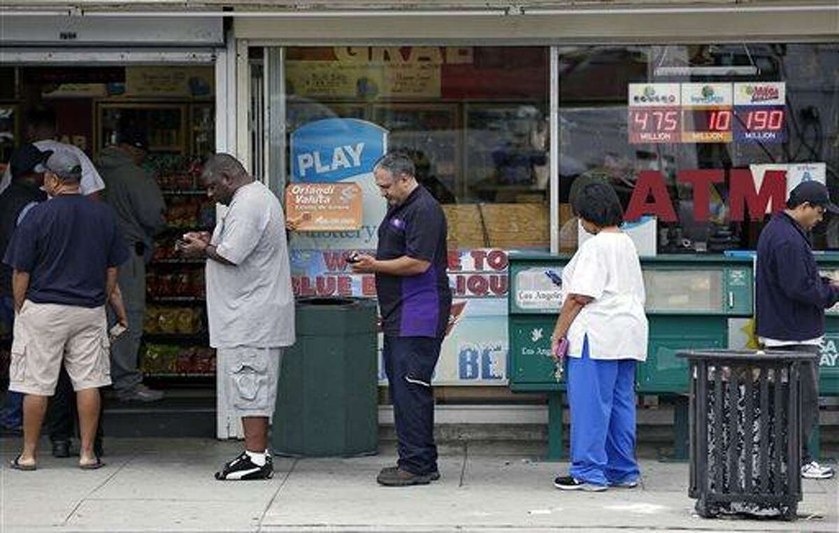 People line up to buy lottery tickets at the Bluebird Liquor store in Hawthorne, Calif. Thursday, May 16, 2013. The multi-state lottery's website said the Powerball drawing jackpot has soared to at least $550 million for next drawing to be held Saturday. (AP Photo/Damian Dovarganes)