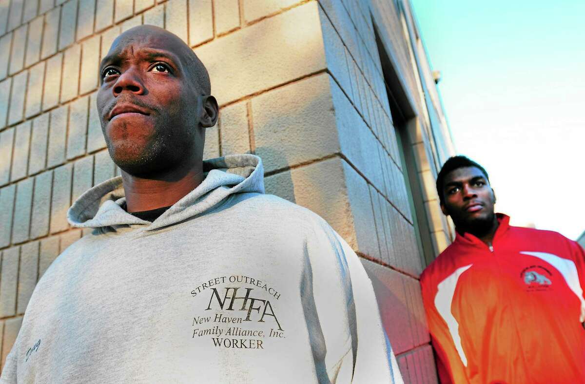 (Peter Hvizdak — Register) Doug Bethea of New Haven, street outreach worker and director of the Nation Drill Squad and Drum Corps, left, has kept Khalid Fleming of New Haven, 20, out of trouble, according to Fleming, a member of Bethea’s drum corps. Bethea says that mentorship from other black men is one way to reduce city gun violence.