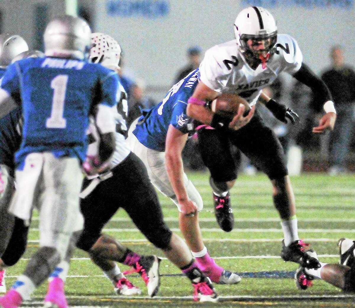 (Peter Hvizdak — Register)Xavier Quarterback Joseph Carbone breaks through the hole for a gain against West Haven H.S.during first quarter football action at West Haven High School Friday evening October 18, 2013.