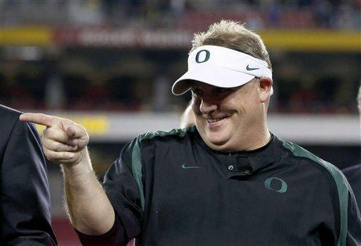 FILE - In this Jan. 3, 2013 file photo, Oregon head coach Chip Kelly celebrates with his players after the Fiesta Bowl NCAA college football game against Kansas State, in Glendale, Ariz. The Philadelphia Eagles have hired Kelly after he originally chose to stay at Oregon. Kelly becomes the 21st coach in team history and replaces Andy Reid, who was fired on Dec. 31 after a 4-12 season. (AP Photo/Ross D. Franklin, FIle)
