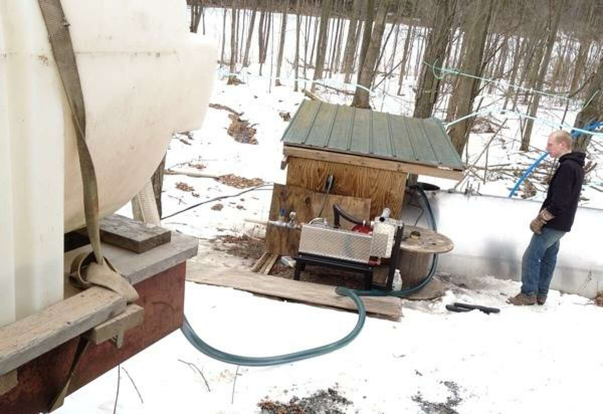 John Haeger @OneidaPhoto on Twitter/Oneida Daily Dispatch VVS FFA member Zack Wheelock collects.sap from the collection tank in the wood lot to be taken back to the sap house and boiled down into maple sypra on Thursday, March 7, 2013.