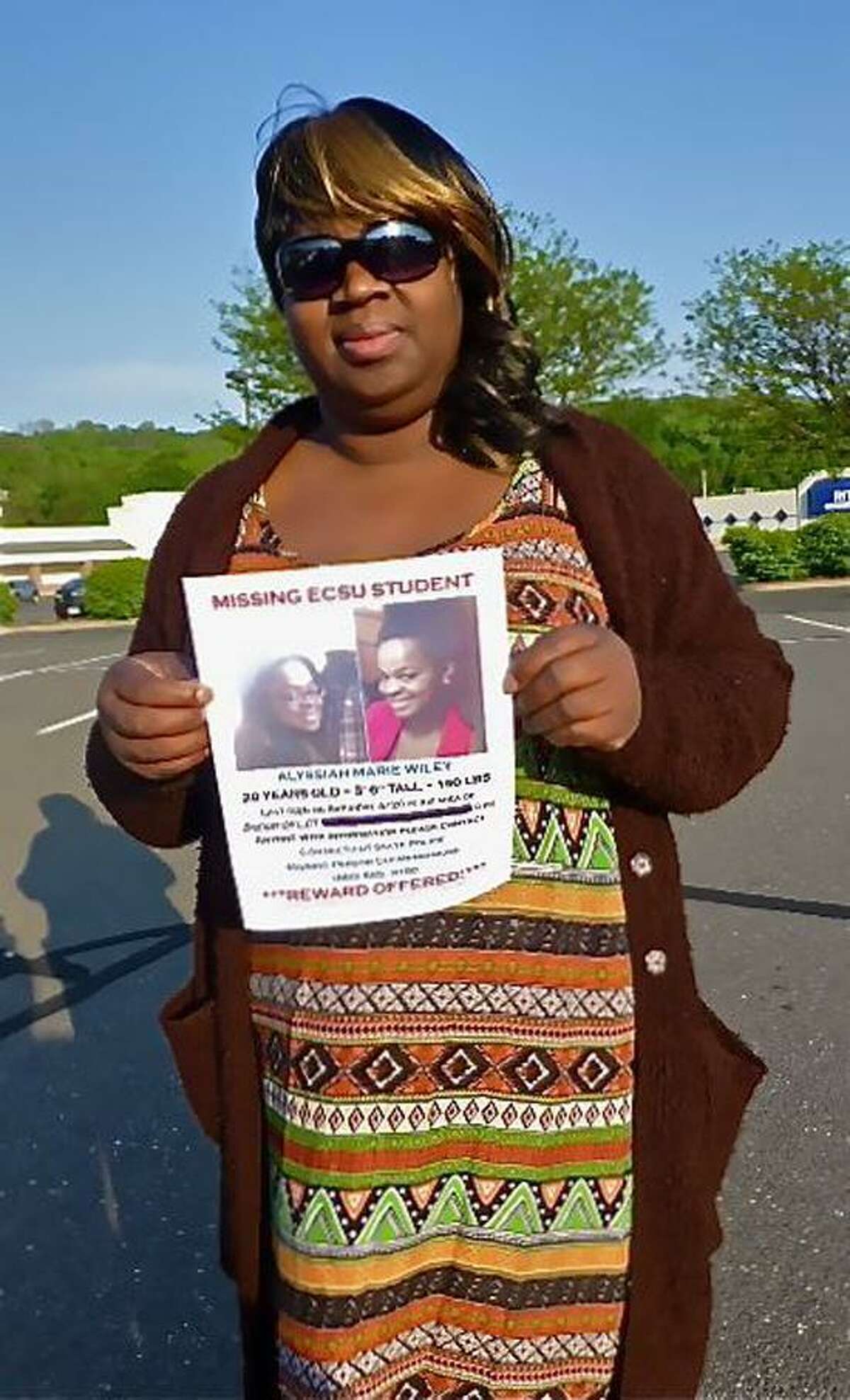Corinna Martin, the mother of missing ECSU student Alyssiah Marie Wiley, holds her daughter's missing person poster Wednesday. Patricia Villers/Register file photo