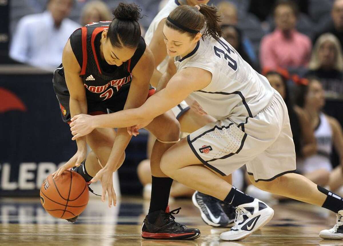 Connecticut's Kelly Faris, right, pressures Louisville's Bria Smith, left, during the first half of an NCAA college basketball game in Hartford, Conn., Tuesday, Jan. 15, 2013. (AP Photo/Jessica Hill)