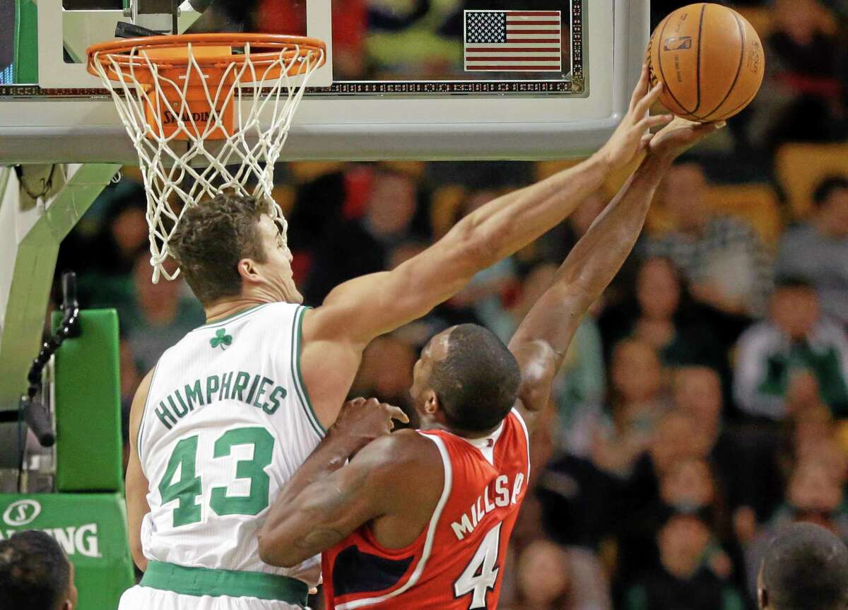 Celtics forward Kris Humphries tries to block Hawks forward Paul Millsap during the first quarter Tuesday at the TD Garden in Boston. Atlanta won 92-91.