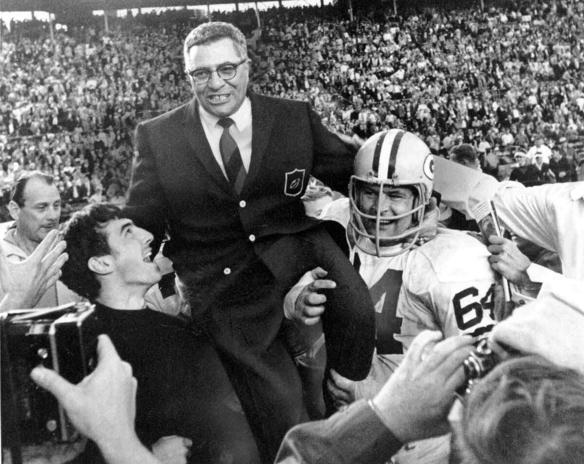 Green Bay Packers coach Vince Lombardi is carried off the field after his team defeated the Oakland Raiders 33 to 14 in the Super Bowl II game in Miami, Fla. on Jan. 14, 1968. Packers guard Jerry Kramer (64) is at right. (AP Photo)