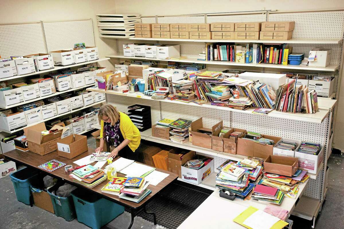 Linda Sylvester, Books for Kids coordinator, cleans incoming books at the Read to Grow office at 53 School House Road in Branford.