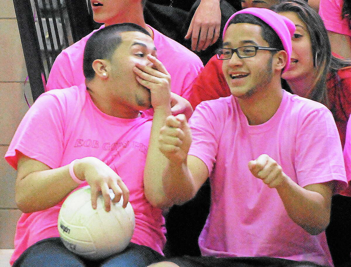 Emmett O’Brien Technical High School students Ivan Devillegas, left, and Christian Rodriquez, both of Bridgeport, react on the sidelines during the Emmett O’Brien Goes Pink Day volleyball game Friday.