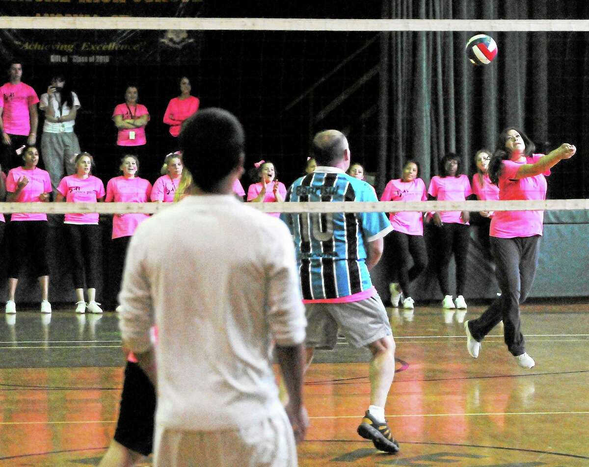 Allison Kinard, an Emmett O’Brien Technical High School social studies teacher and cheerleading coach, volleys during the Emmett O’Brien Goes Pink Day volleyball game Friday.
