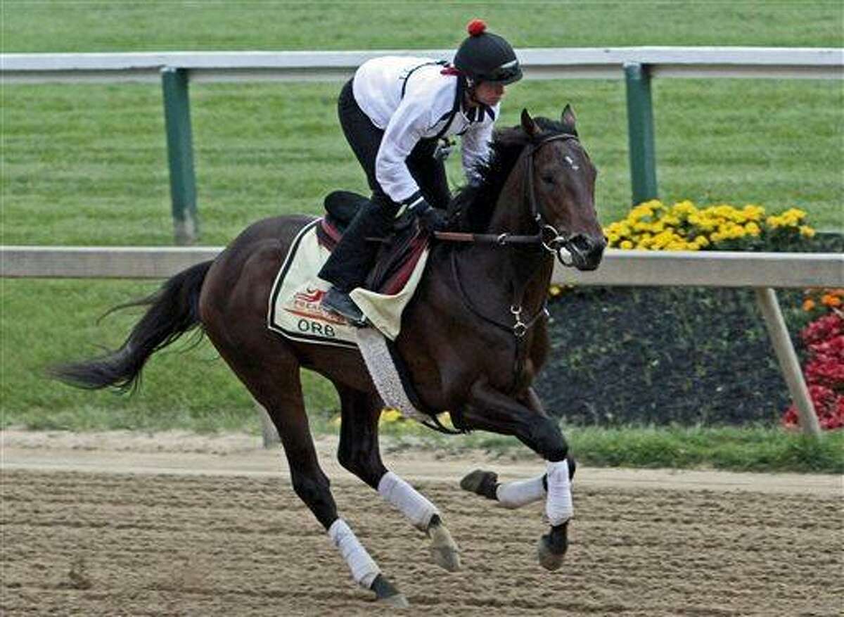 Exercise rider Jenn Patterson gallops Kentucky Derby winner and Preakness Stakes favorite Orb at Pimlico Race Course in Baltimore, Thursday, May 16, 2013. (AP Photo/Garry Jones)