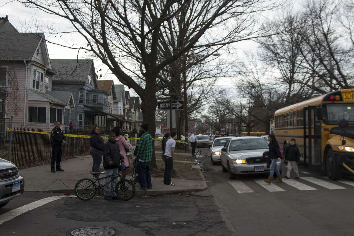 Young students appeared shocked after they were dropped off to a swarm of police cars Monday afternoon at the corner of Howard Avenue and First Street. Police had two people in custody after shots were fired on Columbus Avenue and were searching for additional suspects. Photo by Rich Scinto.