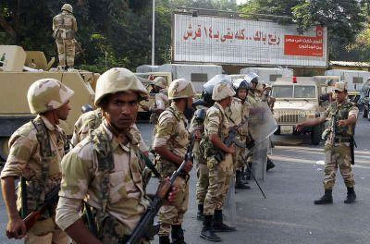 Army soldiers stand guard near supporters (not pictured) of overthrown President Mohamed Mursi and the Muslim Brotherhood, around Cairo University and Nahdet Misr Square in Giza, on the outskirts of Cairo July 4, 2013.