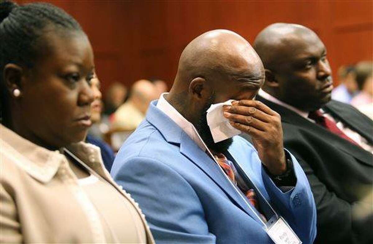 The father of Trayvon Martin, Tracy Martin, cries as he listens to the description of his son's death during opening statements in the George Zimmerman trial, with Sybrina Fulton, Trayvon's mother, left, and Daryl Parks, a family attorney, right, in Seminole circuit court, in Sanford, Fla., Monday, June 24, 2013. Zimmerman has been charged with second-degree murder for the 2012 shooting death of Trayvon Martin. (AP Photo/Orlando Sentinel, Joe Burbank/Pool)