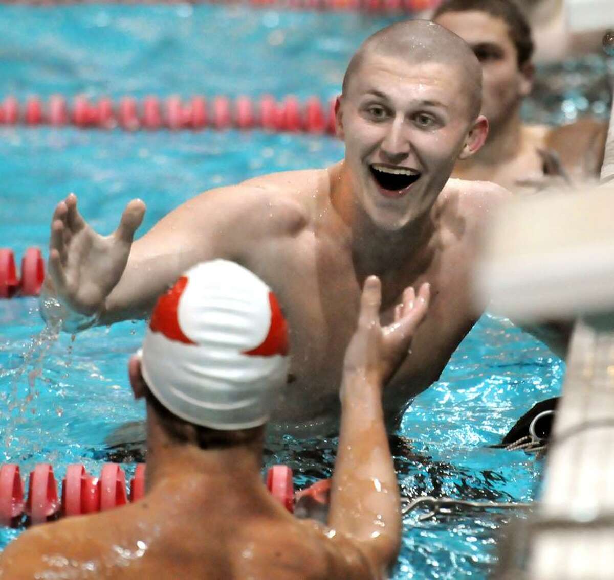 CIAC Class LL Swim Championship, Wesleyan U, 50 Yard Freestyle: Fairfield Prep's Bjorn Davis reacts when seeing that he tied for first at 20.98 with Greenwich's Edward Moss, back of head, as they reach to congratulate each other. Mara Lavitt/New Haven Register3/12/13