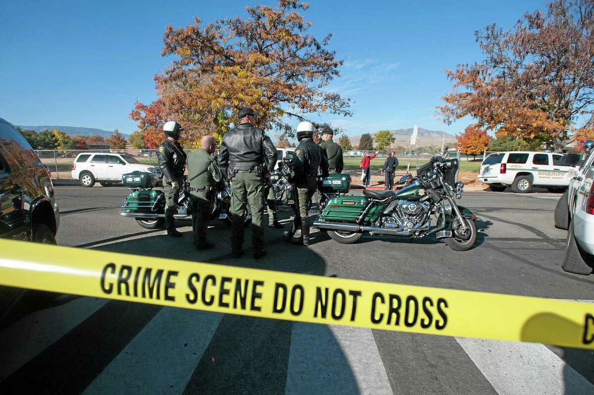 Police secure the scene near Sparks Middle School after a shooting in Sparks, Nev., on Monday, Oct. 21, 2013. Authorities are reporting that two people were killed and two wounded at the Nevada middle school. (AP Photo/Kevin Clifford)