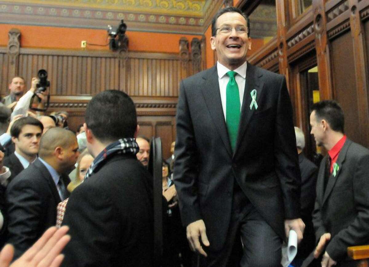 Connecticut Gov. Dannel P. Malloy enters the Hall of the House Wednesday to give the 2012 State of the State Address at the State Capitol in Hartford. In his speech, Malloy said, "When it comes to preventing future acts of violence in our schools, let me say this: more guns are not the answer." Peter Hvizdak/Register