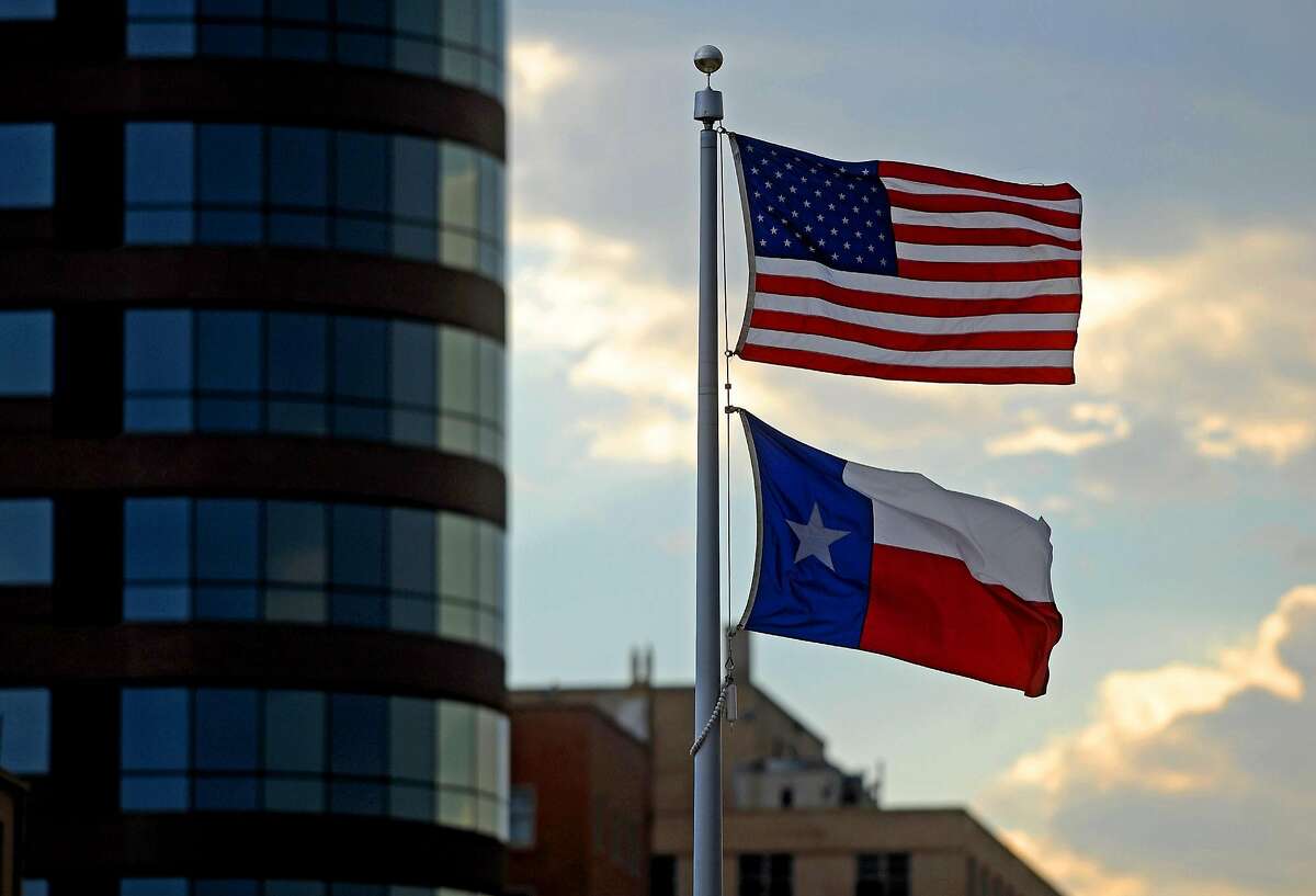 A United States flag flies over a Texas state flag outside the Midland Municipal Court building on June 13, 2017. James Durbin/Reporter-Telegram