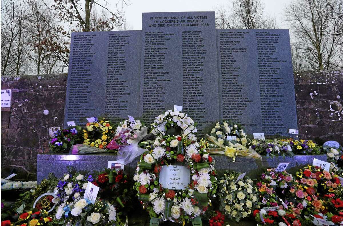 Floral tributes have been laid at the main memorial stone in memory of the victims of Pan Am flight 103 bombing, in the garden of remembrance at Dryfesdale Cemetery, near Lockerbie, Scotland. Saturday Dec. 21, 2013. Pan Am flight 103 was blown apart above the Scottish border town of Lockerbie on Dec. 21, 1988. All 269 passengers and crew on the flight and 11 people on the ground were killed in the bombing. (AP Photo/Scott Heppell).