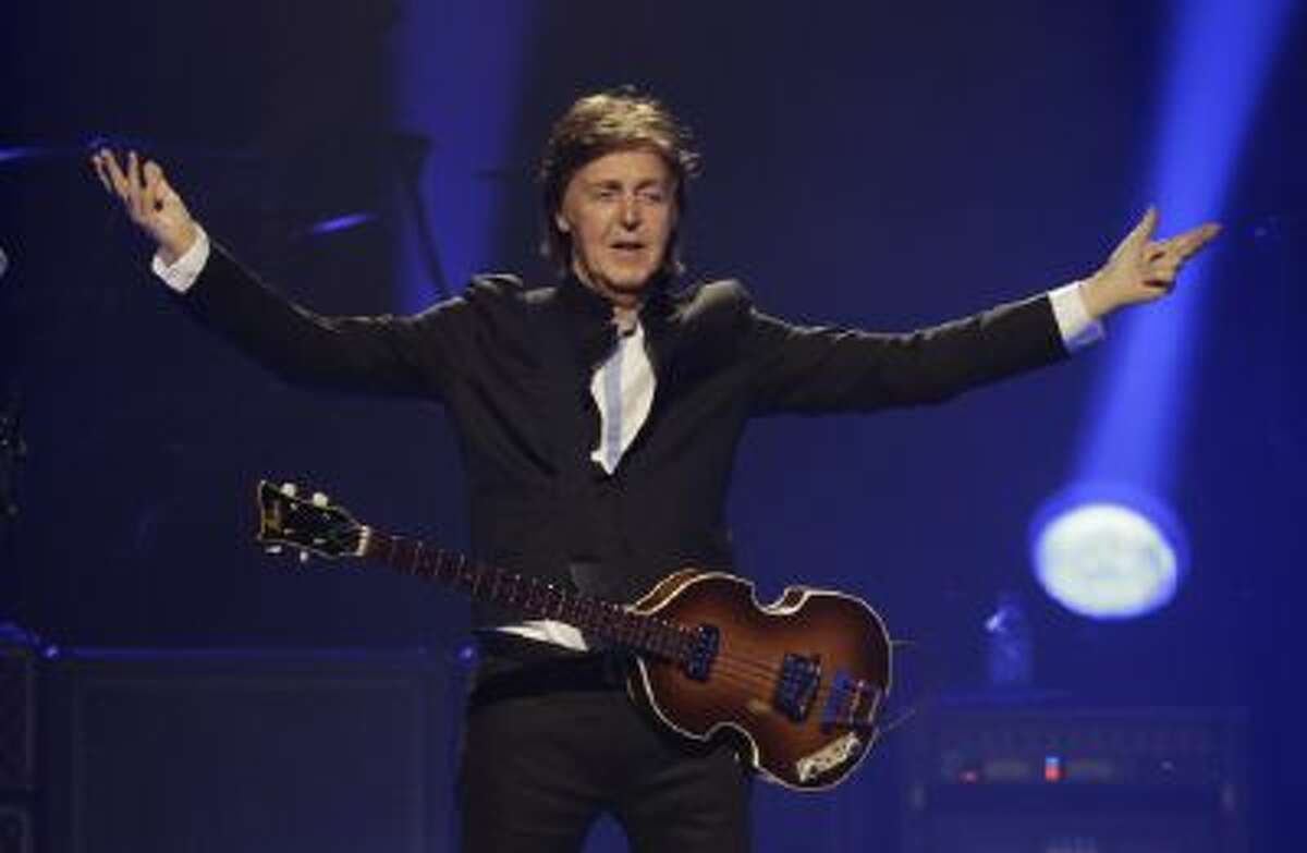 In this Saturday, May 18, 2013 photo, Paul McCartney performs during the first U.S concert of his "Out There" tour, in Orlando, Fla.