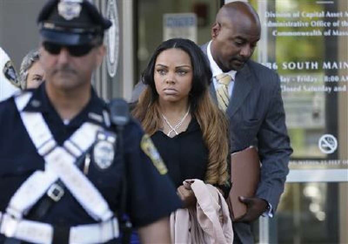 Shayanna Jenkins, center, girlfriend of former New England Patriots' Aaron Hernandez, departs superior court, in Fall River, Mass., Tuesday, Oct. 15, 2013, following her arraignment on a perjury charge in connection with the killing of Hernandez's friend. Authorities say Jenkins, 24, was untruthful in her testimony before the grand jury investigating the death of Odin Lloyd.