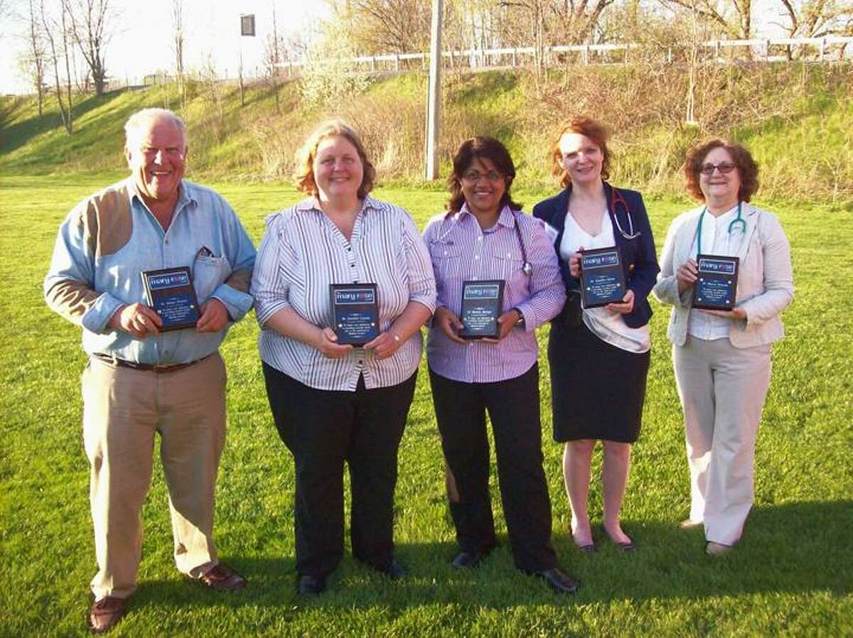 Photo by Mike Jaquays Mary Rose Center volunteer Doctors, from left, Robert Pickels, Jennifer Cesana, Rathika Martyn, Jennifer Quinn, and Marcia Newsom hold the plaques awarded to them by Gorman Foundation president Amanda Larson on May 1, 2013. The Gorman Foundation, who created the Oneida clinic for the uninsured with Dr. Martyn in 2010, made the presentation in honor of the recent National Doctors Day and Volunteers Week.