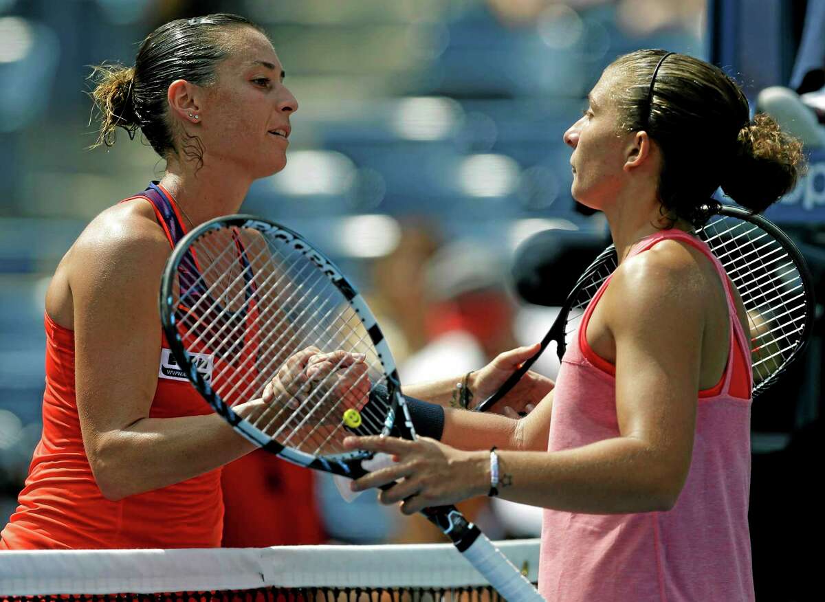 Flavia Pennetta greets Sara Errani at the net after beating Errani in their second-round match at the U.S. Open Thursday in New York.