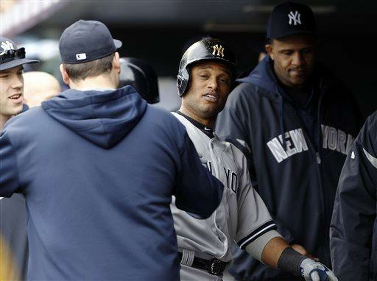 Robinson Cano of the New York Yankees is congratulated by