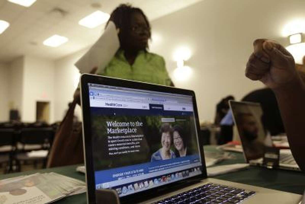 A computer screen shows a website run by the federal government where people can enroll for health care exchanges at a community meeting in Miami Gardens, Fla. Due to technology problems, many were unable to sign up on the website for the first few days of the program.