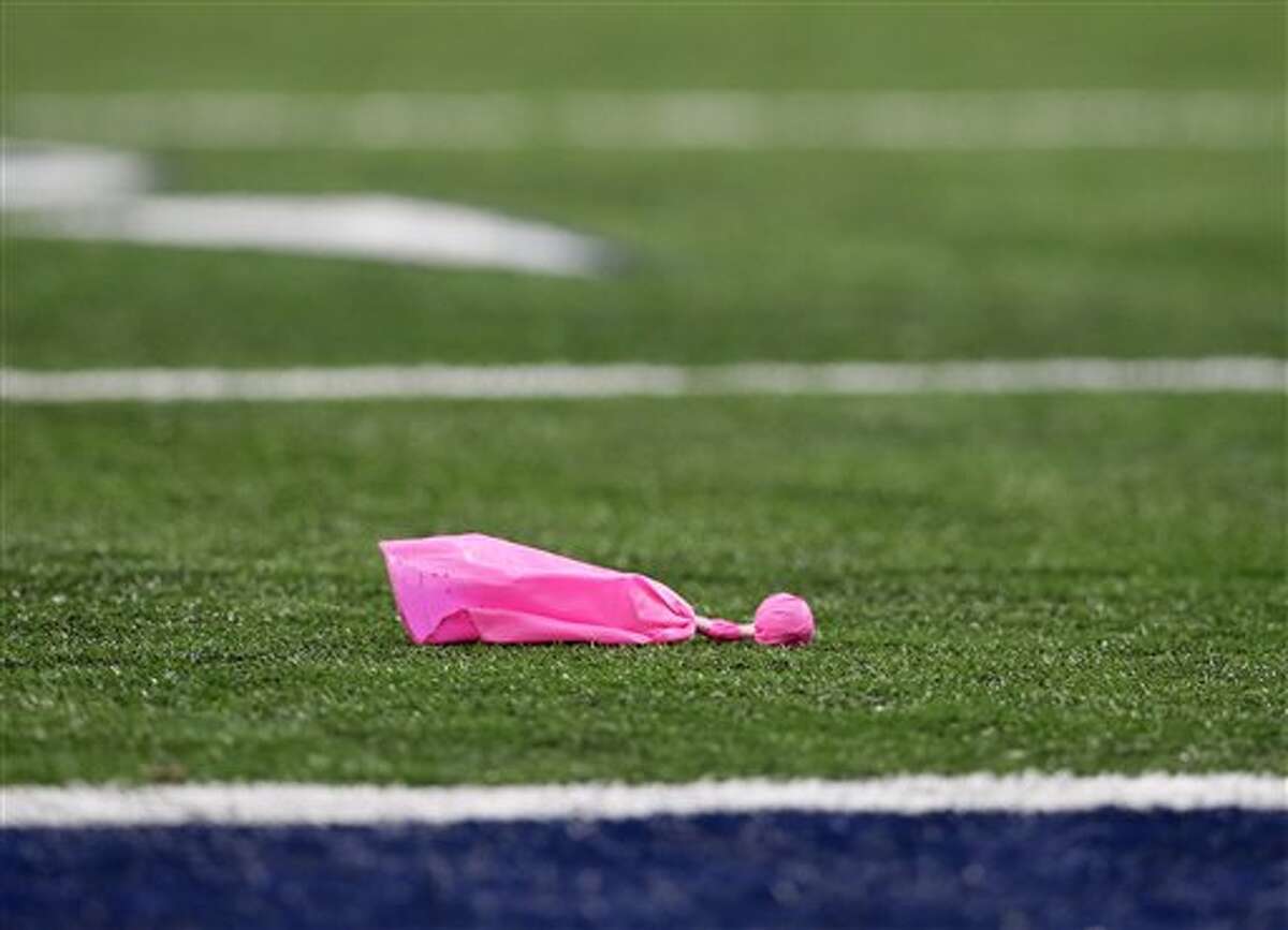 The penalty flags are pink in support of breast dance awareness during the first quarter of an NFL football game between the Dallas Cowboys and the Denver Broncos Sunday, Oct. 6,2013, in Arlington, Texas. (Tony Gutierrez/AP)