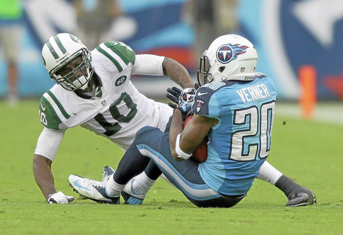 Tennessee Titans cornerback Alterraun Verner intercepts a pass intended for New York Jets wide receiver Santonio Holmes in the second quarter of Sunday’s game in Nashville, Tenn.