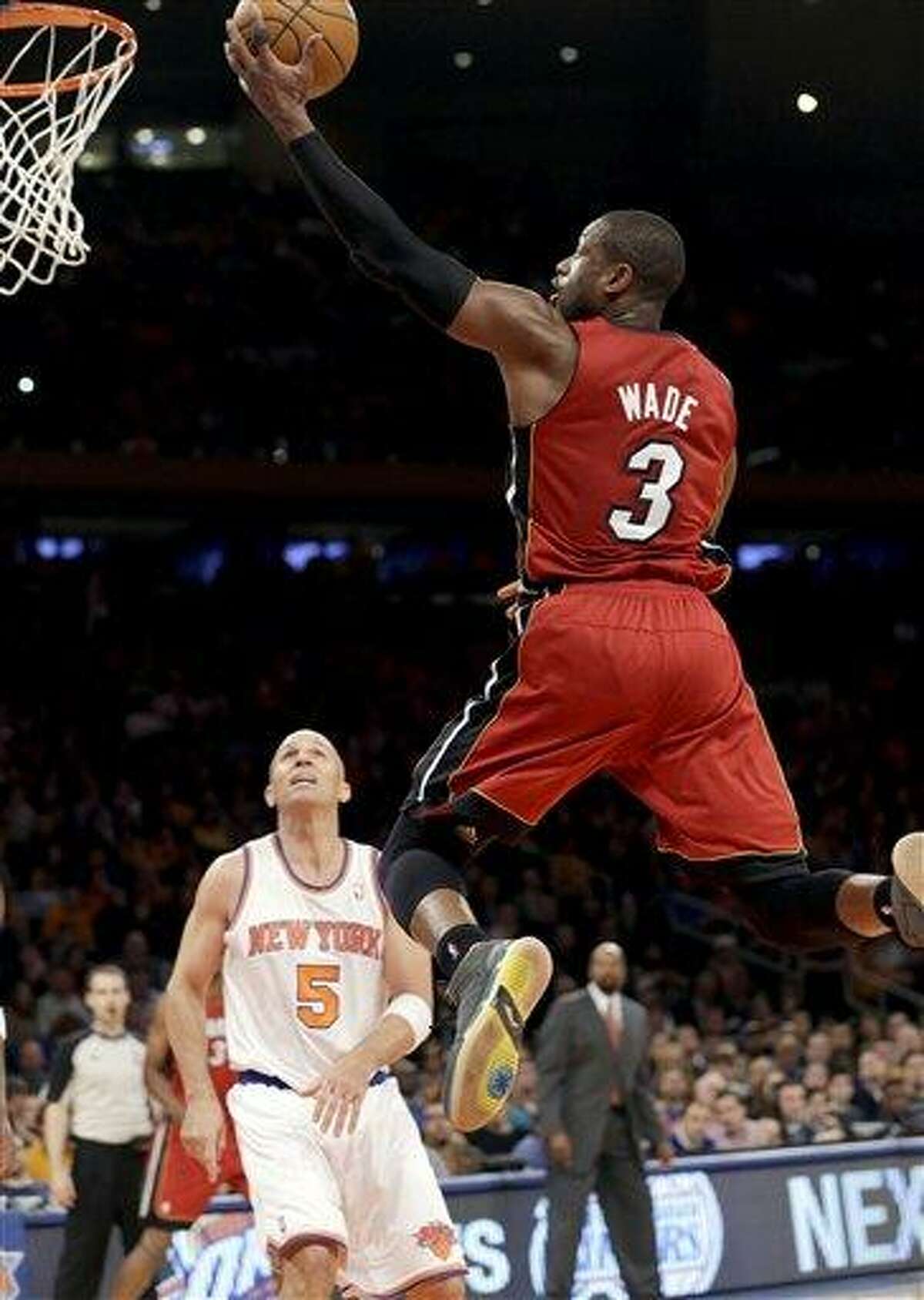 Miami Heat guard Dwyane Wade (3) shoots a layup in front of New York Knicks guard Jason Kidd (5) during the second half of their NBA basketball game at Madison Square Garden in New York, Sunday, March 3, 2013. Wade scored 20 points as the Heat won 99-93. (AP Photo/Kathy Willens)