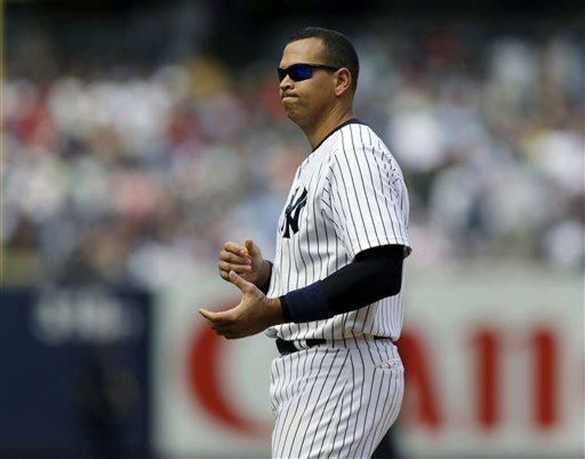 New York Yankees' Alex Rodriguez reacts after flying out to center field with Alfonso Soriano on second during the seventh inning of a baseball game against the Los Angeles Angels, Thursday, Aug. 15, 2013, in New York. (AP Photo/Kathy Willens)
