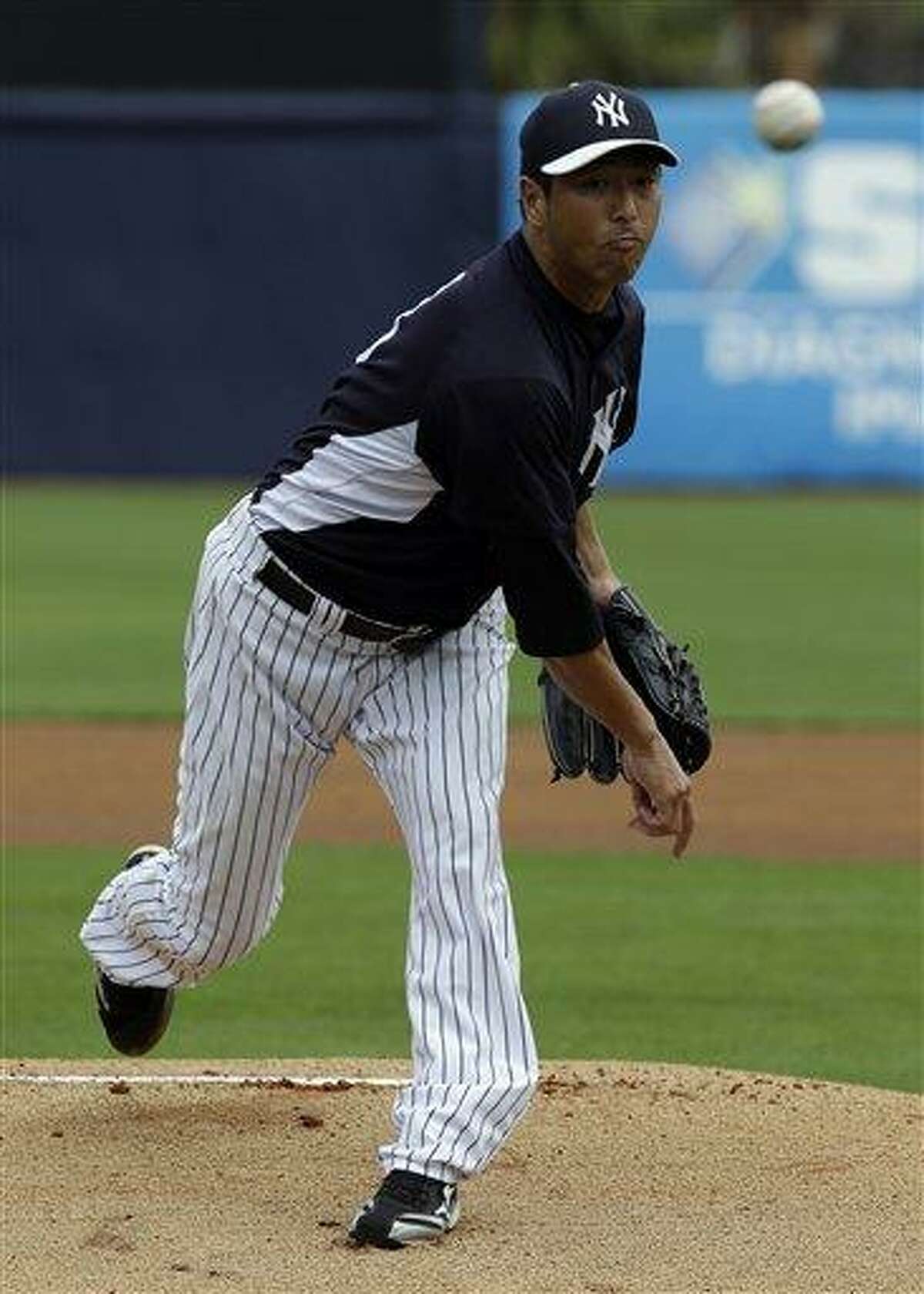 New York Yankees pitcher Hiroki Kuroda, of Japan, delivers to the Philadelphia Phillies during a MLB spring training baseball game Friday, March 1, 2013, in Tampa, Fla. (AP Photo/Chris O'Meara)