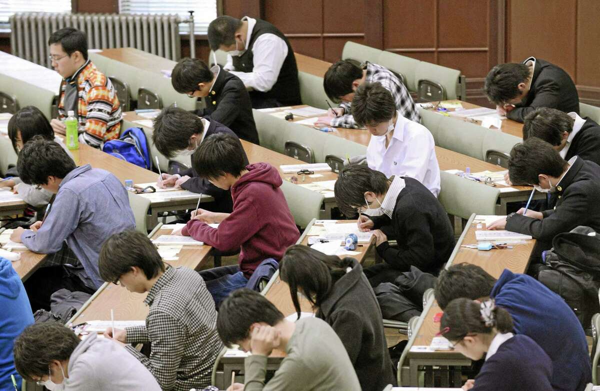 In this January 2013 photo, preparatory students sit for National Center Test for University Admissions at the University of Tokyo. Students from Shanghai, Hong Kong, Singapore, Taiwan, Japan and South Korea were among the highest-ranking groups in math, science and reading in test results released Tuesday, Dec. 3, 2013 by the Program for International Student Assessment (PISA) coordinated by the Paris-based Organization for Economic Cooperation and Development (OECD). The group tests students worldwide every three years. In Japan, the government added 1,200 pages to elementary school textbooks after its children fell behind in those in rivals such as South Korea and Hong Kong in 2009, although Japan’s scores for 2009 were tops for rich industrialized countries. Japan has since improved its standings in all three areas. (AP Photo/Kyodo News) JAPAN OUT, CREDIT MANDATORY
