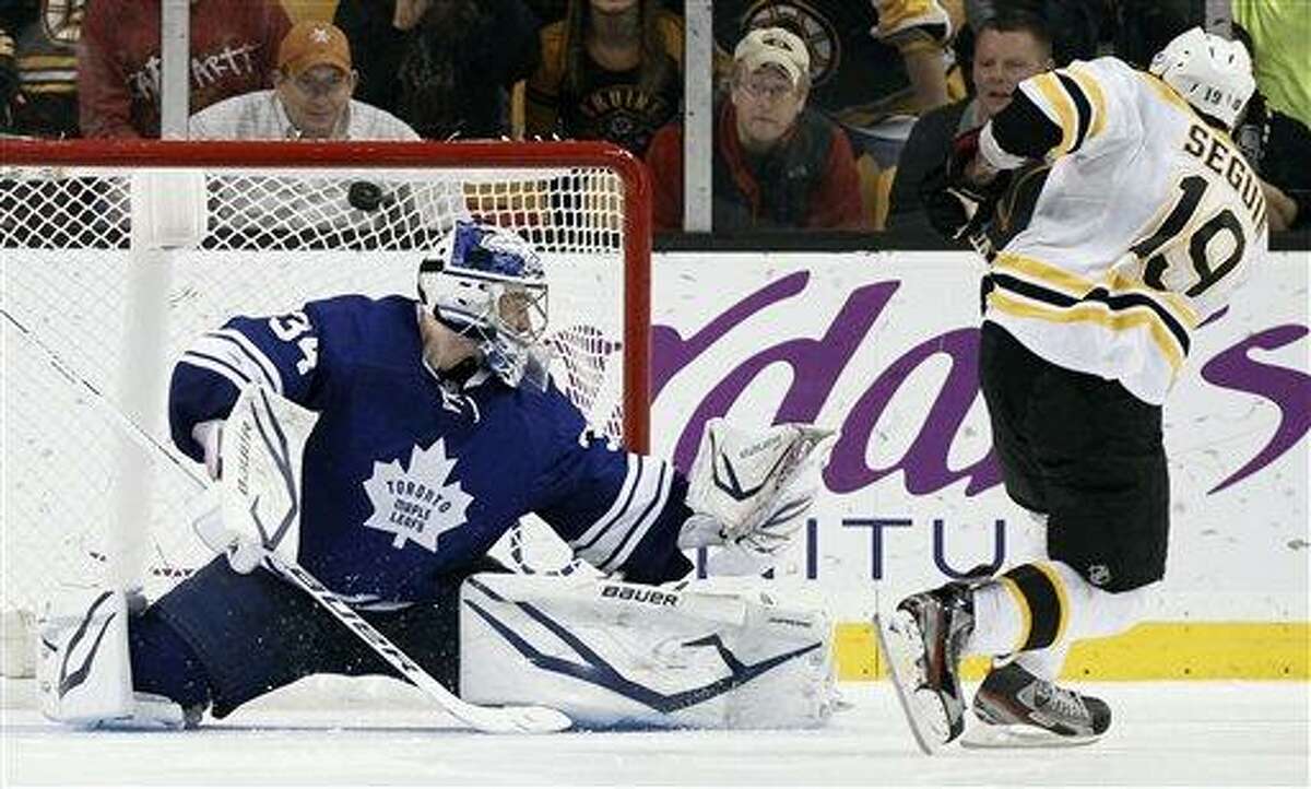 Boston Bruins' Tyler Seguin scores on Toronto Maple Leafs goalie James Reimer during the shootout in Boston's 3-2 win in an NHL hockey game in Boston on Monday, March 25, 2013. (AP Photo/Winslow Townson)