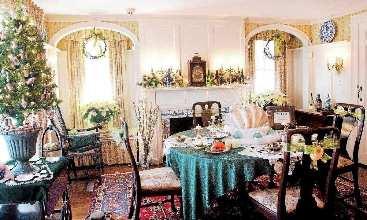 (Melanie Stengel — New Haven Register) The table is set for an elegant seafood dinner at the Frances Osbourne Kellog Homestead Museum. Holiday tours began 11/29/.