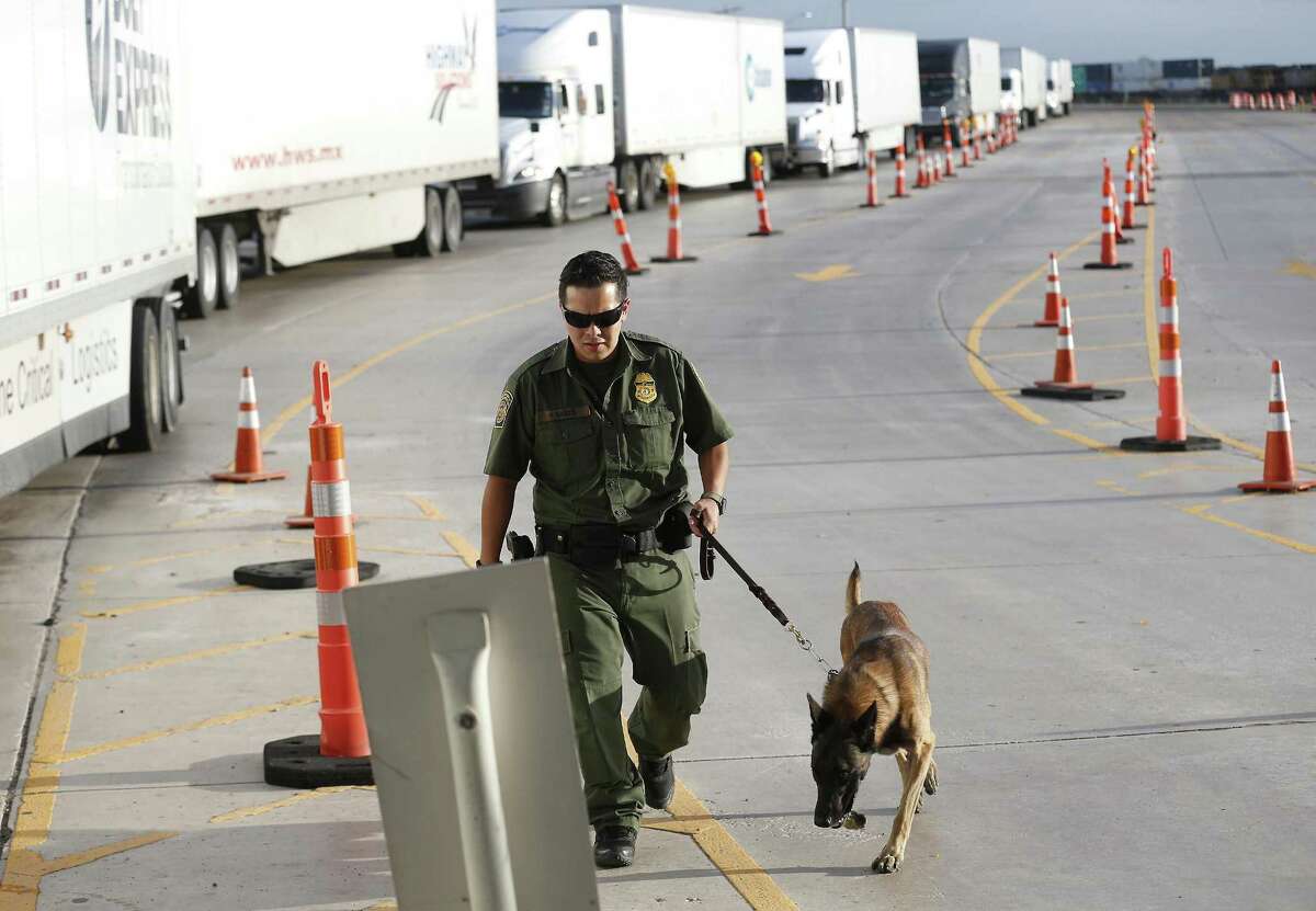 A line of commercial trucks make their way through an inspection station checkpoint as Border Patrol Agent K9 handler officer Garza (no first name used) and his inspection dog make the rounds 27 miles outside Laredo on Tuesday, July 25, 2017. The trailer rig driven by James Matthew Bradley, Jr. that smuggled the ill-fated immigrants may or may not have passed this station. On Tuesday, traffic was heavy yet brisk at the station and agents were out in full force to inspect commercial and personal vehicles heading from Laredo to San Antonio. (Kin Man Hui/San Antonio Express-News)