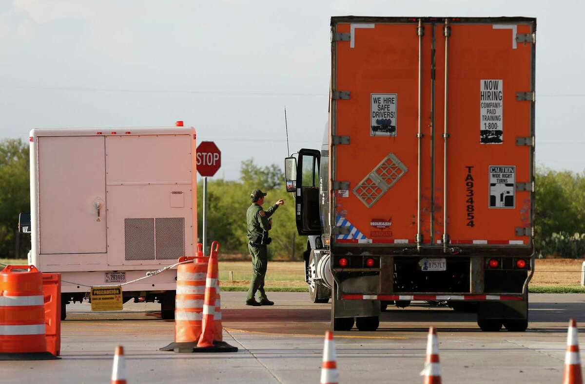 A Customs and Border Patrol agent inspects a commercial truck in the secondary inspection station at the checkpoint 27 miles outside Laredo on Tuesday, July 25, 2017. A number of smugglers hiding undocumented immigrants in their trailers have been caught at the Laredo checkpoints.