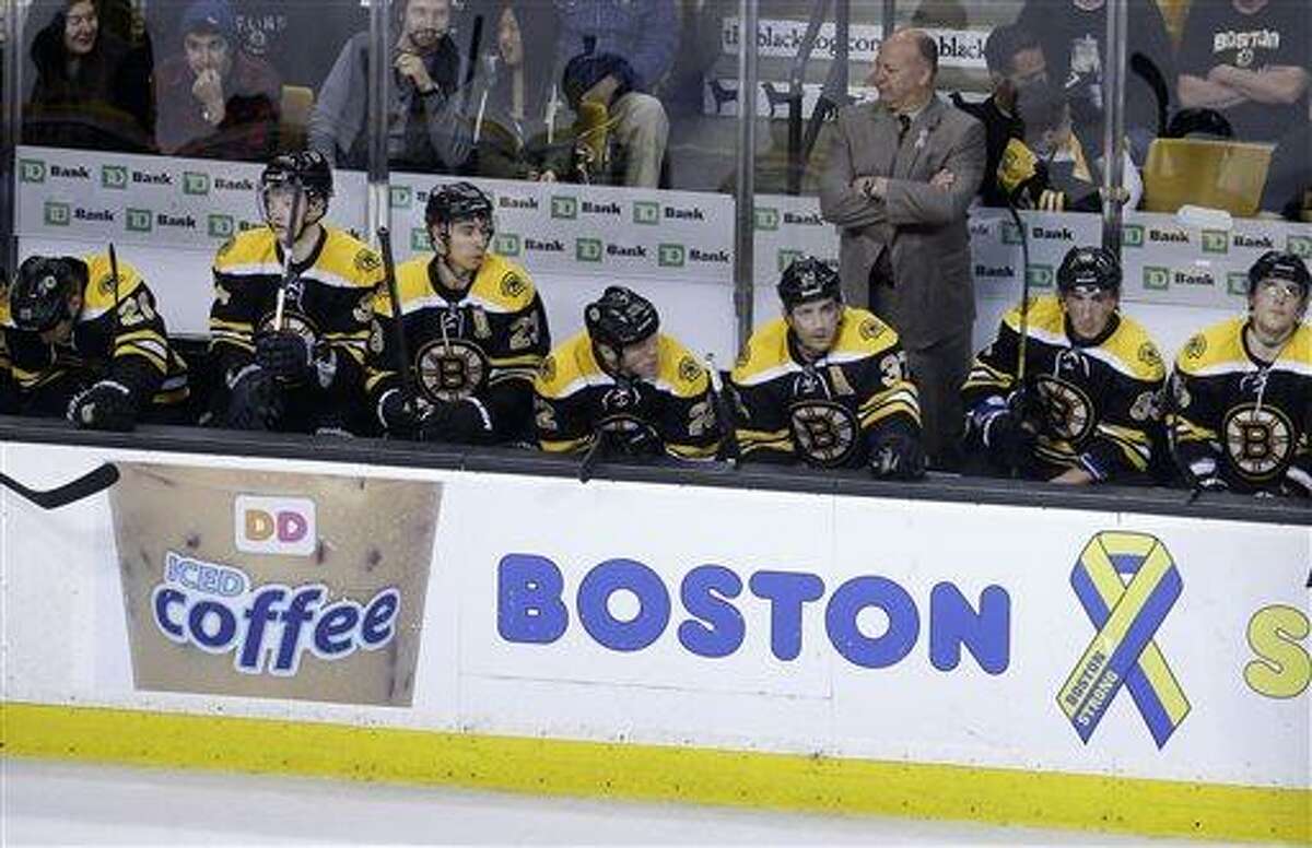 Boston Bruins head coach Claude Julien, top right, and members of the Bruins team react from the bench as they fall behind in the third period of an NHL hockey game against the Ottawa Senators at the TD Garden, in Boston, Sunday, April 28, 2013. The Senators beat the Bruins 4-2. (AP Photo/Steven Senne)
