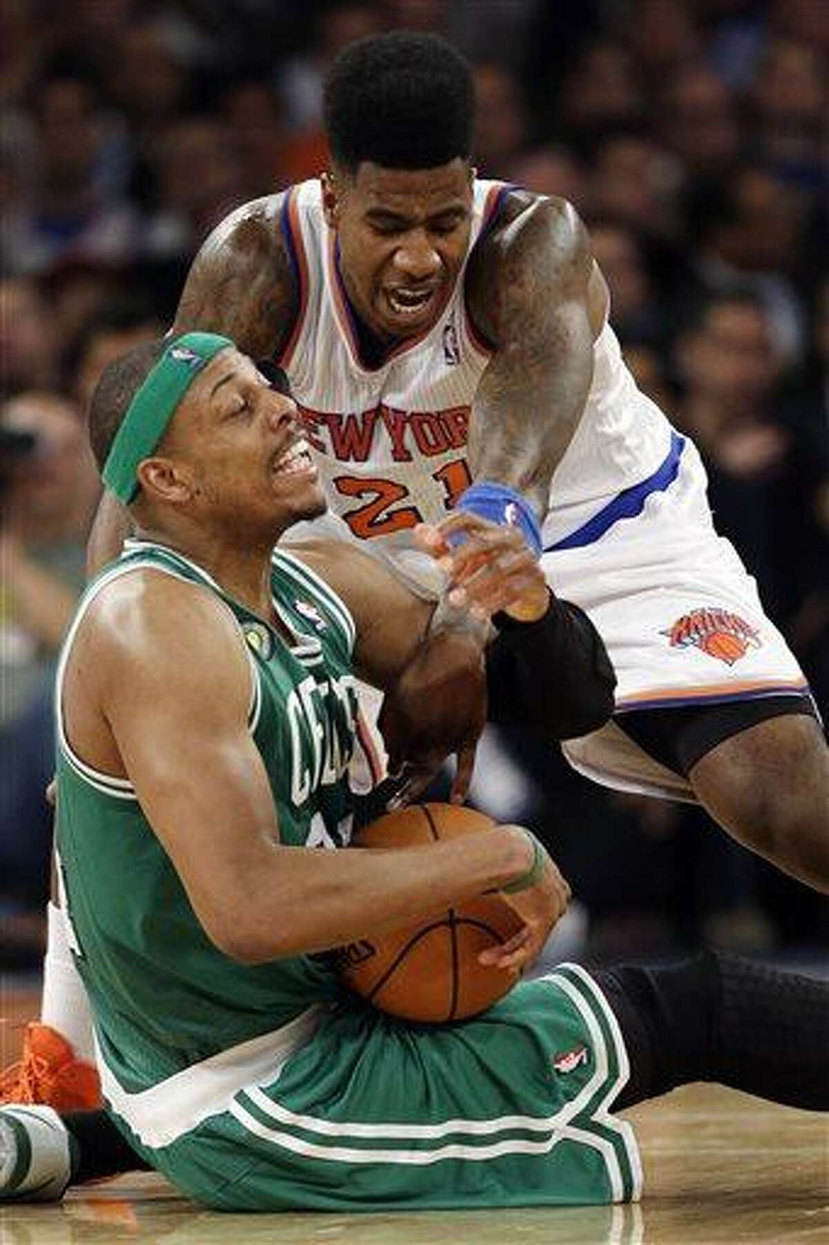 New York Knicks forward Iman Shumpert (21) and Boston Celtics forward Paul Pierce (34) fight for the ball in the first half of Game 5 of their first-round NBA basketball playoff series at Madison Square Garden in New York, Wednesday, May 1, 2013. (AP Photo/Kathy Willens)