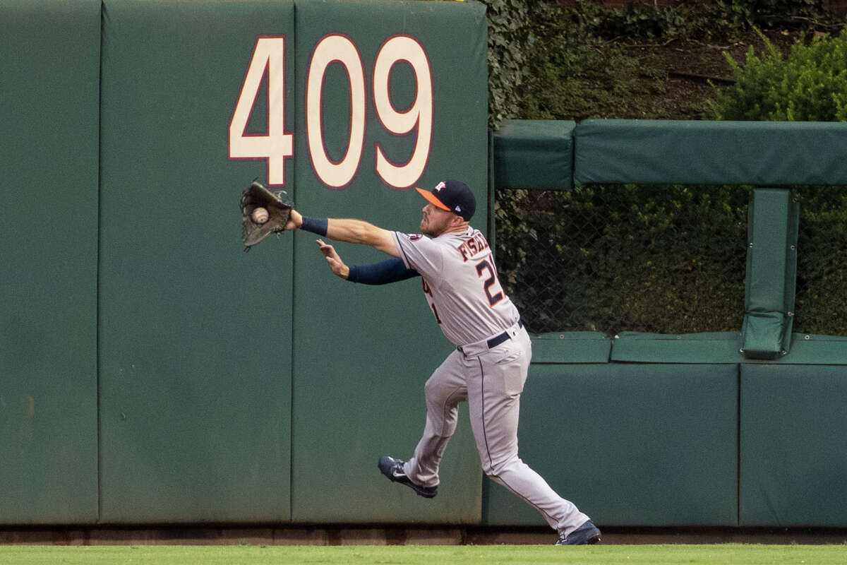Astros center fielder Derek Fisher, starting with George Springer nursing a quad injury, tracks down a ball hit by the Phillies' Odubel Herrera in the first inning.