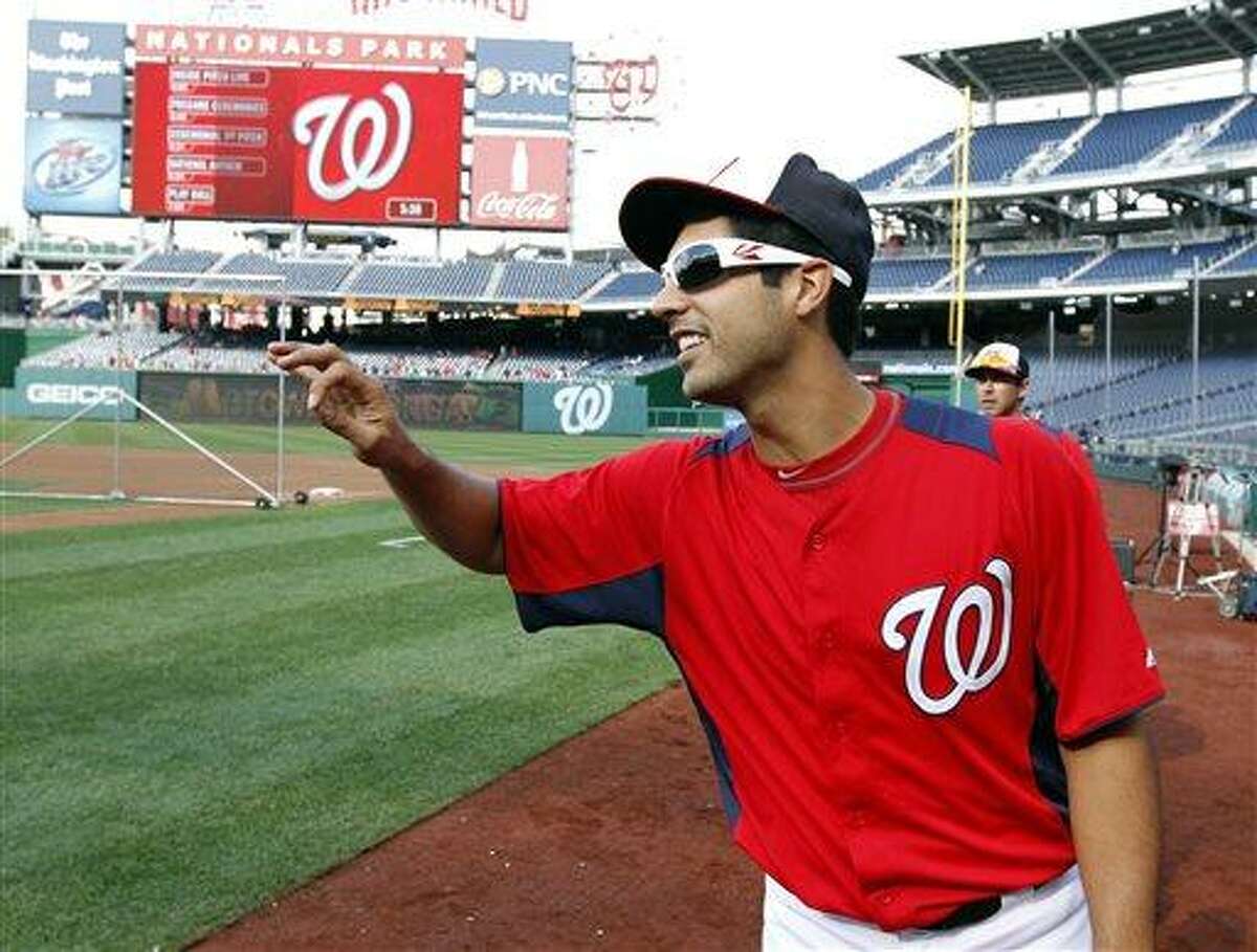 Washington Nationals starting pitcher Gio Gonzalez (47) reacts with members of the Atlanta Braves before a baseball game at Nationals Park, Monday, Aug. 5, 2013, in Washington. (AP Photo/Alex Brandon)