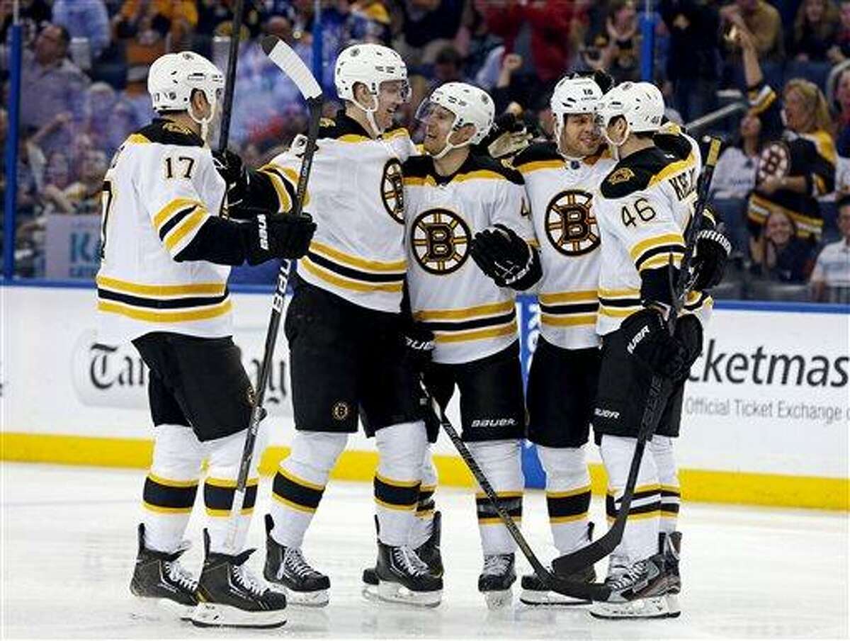 From left, Boston Bruins' Milan Lucic, Dougie Hamilton, Dennis Seidenberg, of Germany, Nathan Horton and David Krejci, of the Czech Republic, celebrate a goal during the first period of an NHL hockey game against the Tampa Bay Lightning, Thursday, Feb. 21, 2013, in Tampa, Fla. (AP Photo/Mike Carlson)