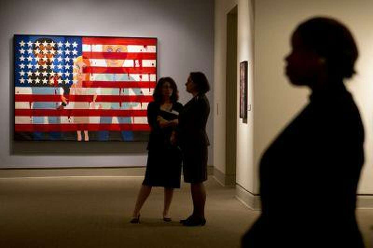 Faith Ringgold's painting, "The Flag is Bleeding," is one of her works on display during a media preview of her exhibition, "American People, Black Light: Faith Ringgold's Paintings of the 1960s" at the National Museum of Women in the Arts in Washington on Wednesday, June 19, 2013. Ringgold explains her "confrontational art" _ vivid paintings whose themes of race, gender, class and civil rights were so intense that for years, no one would buy them. "I didn't want people to be able to look, and look away, because a lot of people do that with art," Ringgold said. "I want them to look and see. I want to grab their eyes and hold them, because this is America." (AP Photo/Jacquelyn Martin)