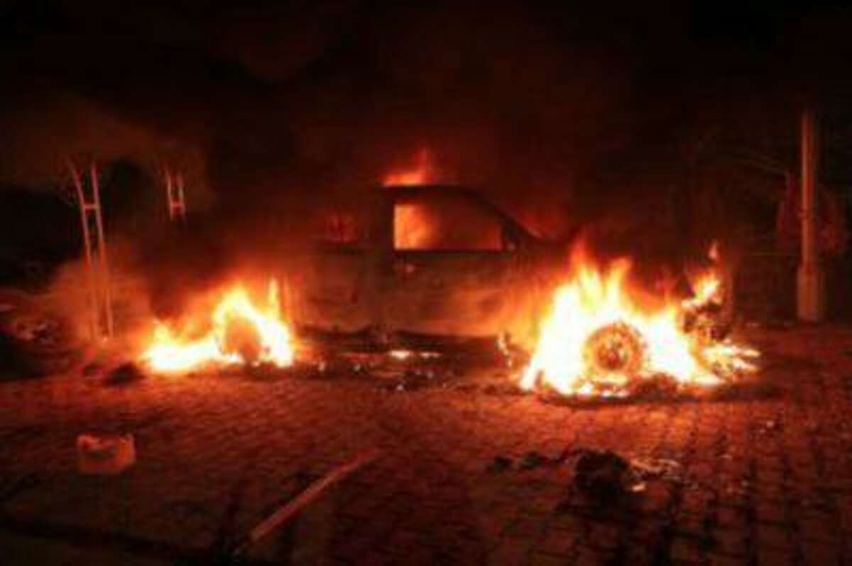 A vehicle and the surrounding area are engulfed in flames after it was set on fire inside the U.S. consulate compound in Benghazi late on September 11, 2012.