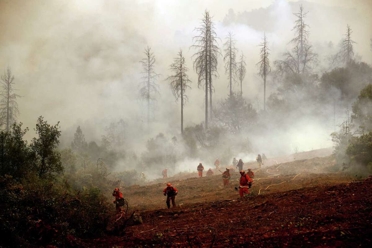 A team of inmate firefighters keep watch on a fire line as they battle the Detwiler Fire on the outskirts of Mariposa on Wednesday, July 19, 2017.