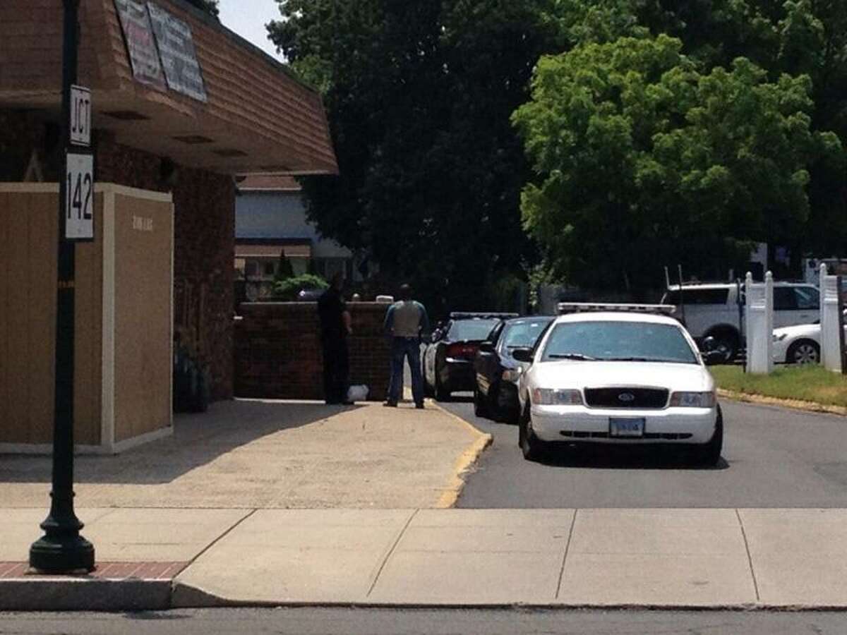 Police cruisers can be seen outside Zodiac Health Club in East Haven. Evan Lips/Register