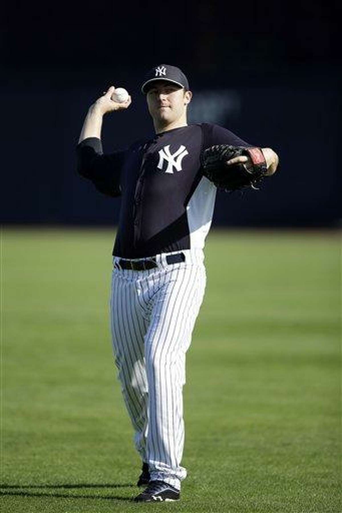 New York Yankees' Phil Hughes pitches during a workout at baseball spring training, Saturday, Feb. 16, 2013, in Tampa, Fla. (AP Photo/Matt Slocum)